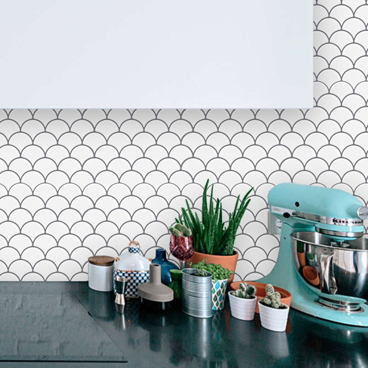 White peel and stick oriental fan tiles with grey grout as a kitchen backsplash