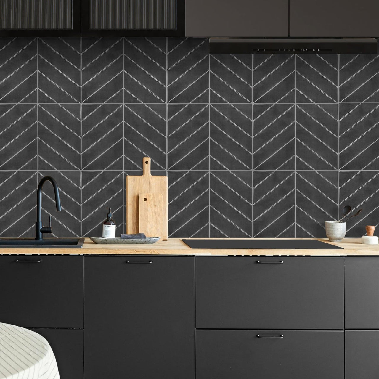 charcoal chevron tiles in black kitchen