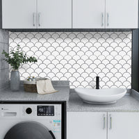 Thumbnail for White peel and stick oriental fan tiles with grey grout as a back splash in a laundry room