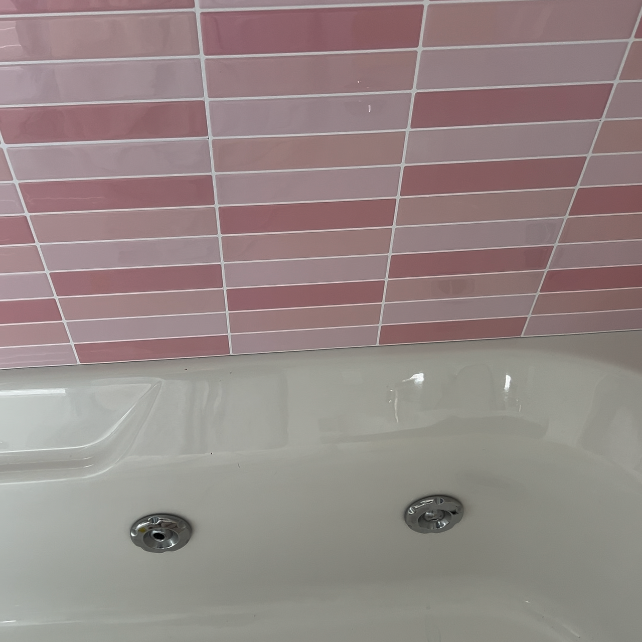 Pink Kit kat tiles above bath