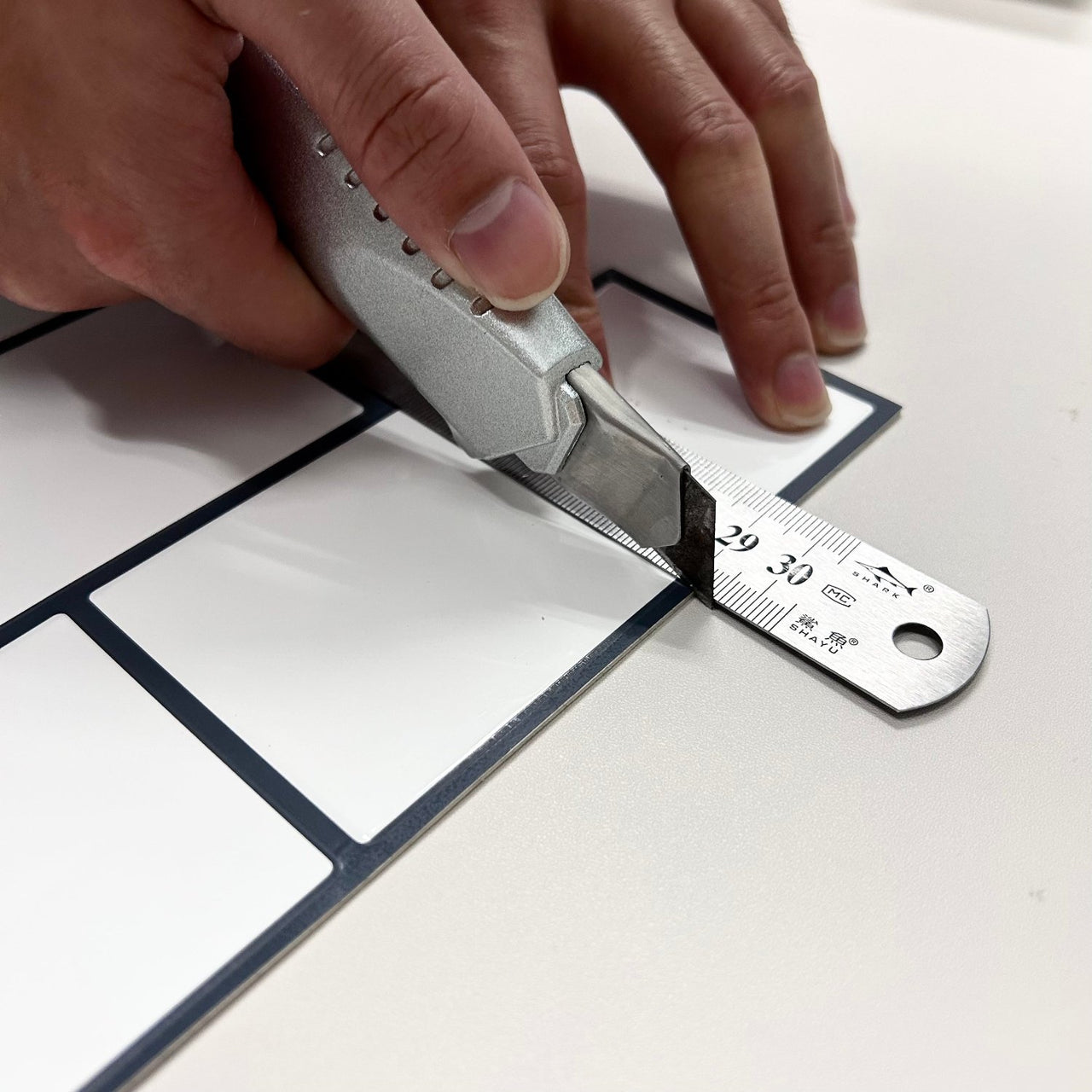 White subway peel and stick tiles being cut