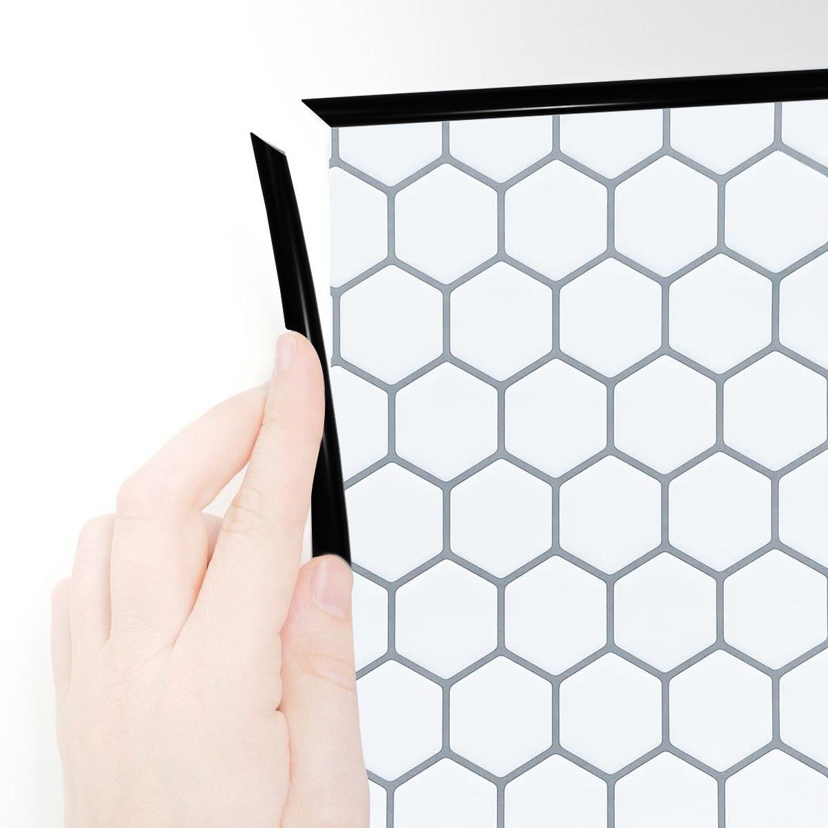 Black edge trim around white hexagon tile