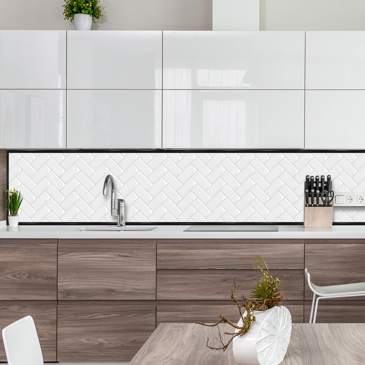 Black edge trim framing white herringbone splash back in kitchen