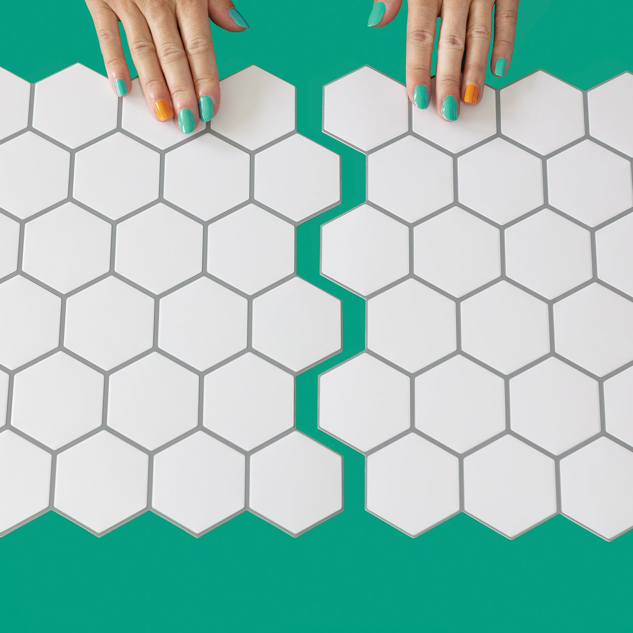 White hexagon peel and stick tiles in interlocking position