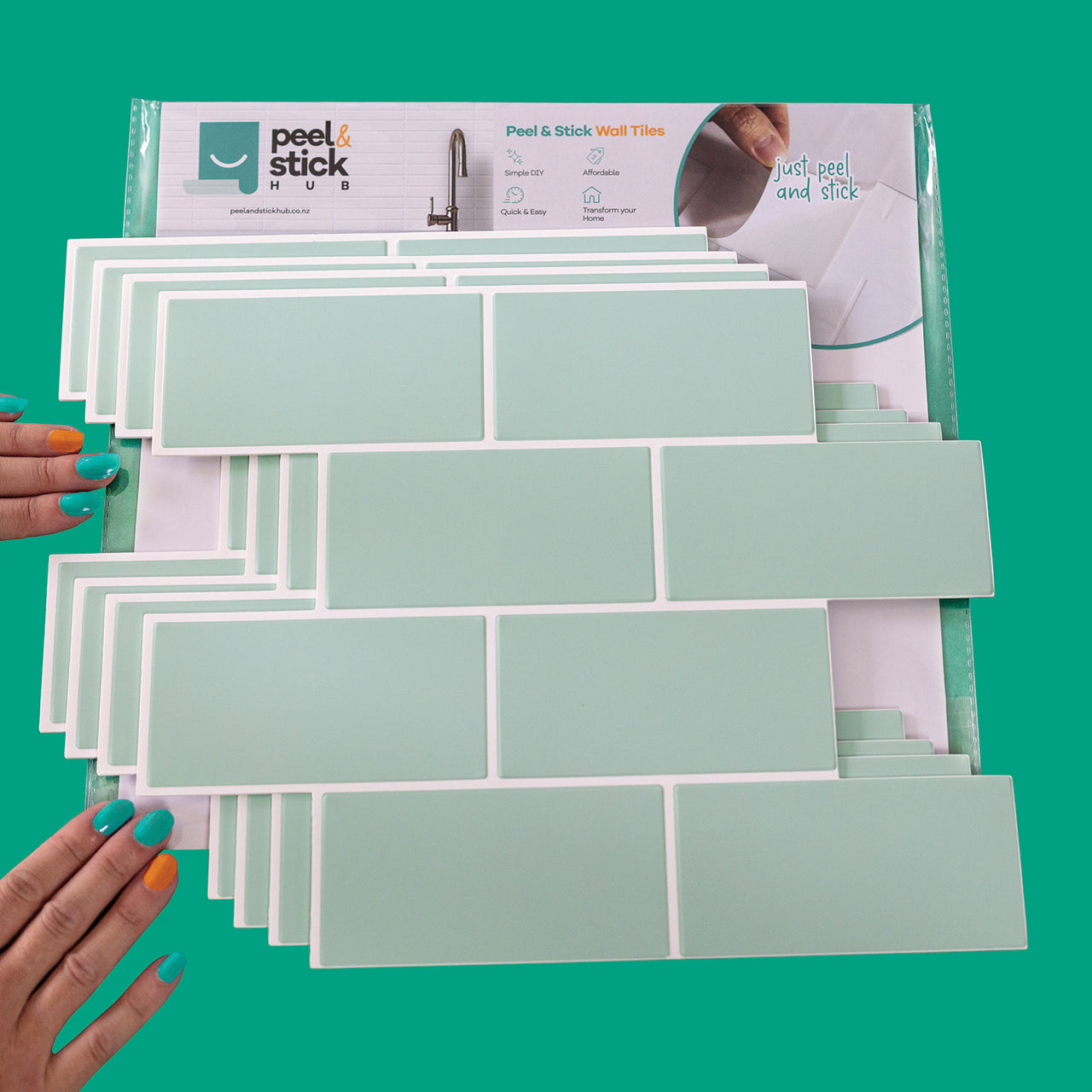 A package of 4 mint green subway peel and stick vinyl wall tiles